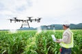 Technician farmer use wifi computer control agriculture drone on sweet corn field