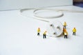Technician figurine maintenance team try to plug switch of electricity