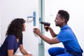 Technician Fixing The Door Lock Royalty Free Stock Photo