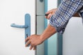 Technician Fixing Lock In Door With Screwdriver Royalty Free Stock Photo