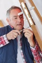 Technician fixing lock in door with screwdriver at home Royalty Free Stock Photo