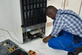 Technician Fixing Refrigerator With Worktool