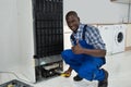 Technician Fixing Refrigerator Royalty Free Stock Photo