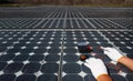 Technician fixing wiring damage of photovoltaic modules (Solar panels) in farm Royalty Free Stock Photo