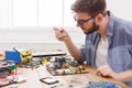 Technician Repairs Motherboard During Electronics Project in Workspace With Tools and Devices Royalty Free Stock Photo
