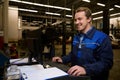 A technician, garage mechanic typing on keyboard, making checklist for repairing cars, conducting diagnostic check of a car during