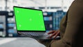 Technician with green screen laptop in data center Royalty Free Stock Photo