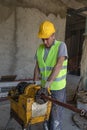 Technician is grooving steel pipe. Iron pipe master working iron pipes at construction site. Worker cutting iron bars Royalty Free Stock Photo