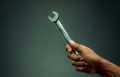 Technician hand holding chrome wrench. Plumber or mechanic technician work with spanner in hand. Mechanic tools. Service and Royalty Free Stock Photo