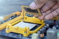 Technician hand holding the CPU or Central Processing Unit chip microprocessor fixing and upgrade computer pc to repair inside The Royalty Free Stock Photo