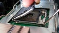 Technician hand open processor socket on boaard