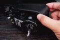 Technician hand is opened back cover of an old film camera Royalty Free Stock Photo