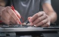 Technician hands checking motherboard with multimeter Royalty Free Stock Photo