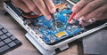 Technician hands checking motherboard with multimeter Royalty Free Stock Photo