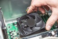 Technician hands installing CPU cooler fan on a computer pc motherboard