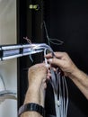 Technician hands installing network cables in server rack Royalty Free Stock Photo