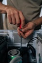 Technician hands maintaining and upgrading a personal computer, assembling internal hardware components with screwdriver Royalty Free Stock Photo