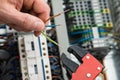 Technician holding cables and work tool Royalty Free Stock Photo