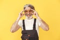 Technician holding instruments on a yellow background