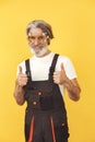 Technician holding instruments on a yellow background