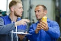 Technician holding voltmeter talking to supervisor Royalty Free Stock Photo