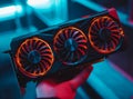A technician holds a top-of-the-line, advanced graphics card for a desktop computer