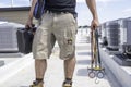 Technician with Hvac tools on Roof Royalty Free Stock Photo