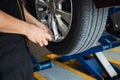 Technician is inflate car tire