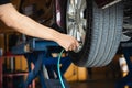 Technician is inflate car tire Royalty Free Stock Photo