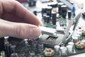 Technician inserting CPU in motherboard