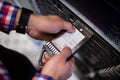 Technician inserting a hard disk drive into a blade server