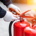 Technician Inspecting a Fire Extinguisher for Safety (1 Royalty Free Stock Photo