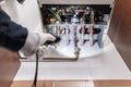 Technician inspecting a gas heater or heating boiler in a house Royalty Free Stock Photo