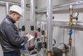 Technician inspecting heating system in boiler room Royalty Free Stock Photo