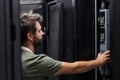 It technician inspecting servers in a data center server rack for maintenance and network support Royalty Free Stock Photo