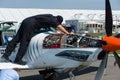 Technician inspects turboprop engine two-seater training and aerobatic low-wing aircraft Grob G 120TP. Royalty Free Stock Photo