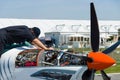 Technician inspects turboprop engine two-seater training and aerobatic low-wing aircraft Grob G 120TP. Royalty Free Stock Photo