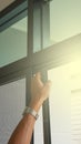 Technician inspects a window frame which is new installed a mosquito wire screen Royalty Free Stock Photo