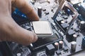 Technician install CPU processor chip in socket Royalty Free Stock Photo