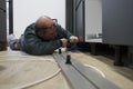 Technician install plastic tubes to connect water filter to american fridge. Royalty Free Stock Photo