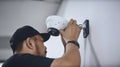 Technician installing CCTV camera for security, AI Generative