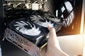 The technician is installing the computer graphics card