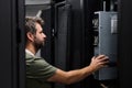 It technician installing and inspecting server hardware in a data center server rack during maintenance Royalty Free Stock Photo