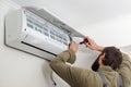 Technician installing new air conditioner. Modern air conditioner during the installation process