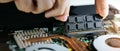 Technician installing ram memory module in laptop motherboard. computer hardware upgrade. copy space Royalty Free Stock Photo
