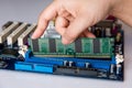 Technician installing RAM stick (random access memory) to socket Royalty Free Stock Photo