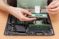 Technician Installing random access memory into PC.