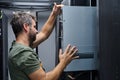 It technician installing a server in a data center rack performing hardware maintenance and network setup Royalty Free Stock Photo