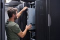 IT technician installing a server in a data center rack during routine maintenance and hardware upgrade Royalty Free Stock Photo