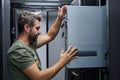 It technician installing server hardware in a data center rack performing maintenance and network setup Royalty Free Stock Photo